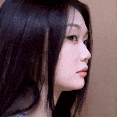 a close up of a woman with long black hair