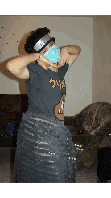 a person wearing a mask and a headband with a naruto logo on it