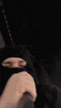 a person with curly hair is wearing a black shirt