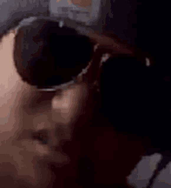 a close up of a person wearing sunglasses .