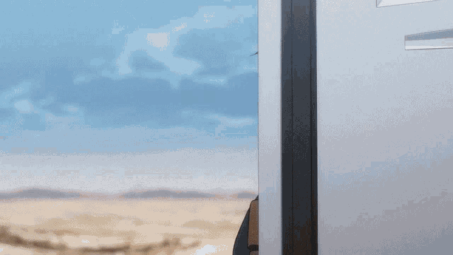a cartoon character is peeking out of a doorway