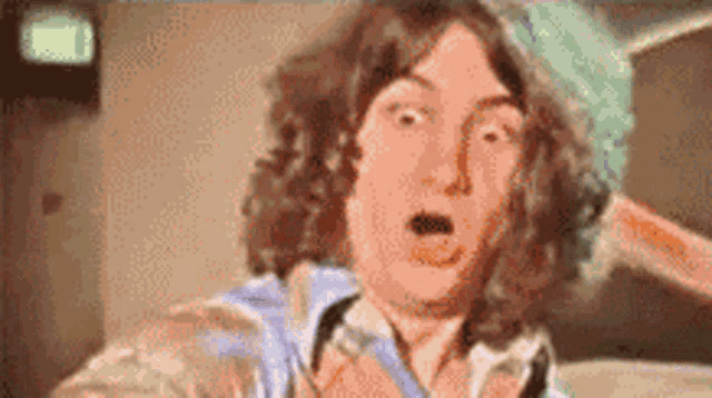 a close up of a person 's face with a surprised look on his face