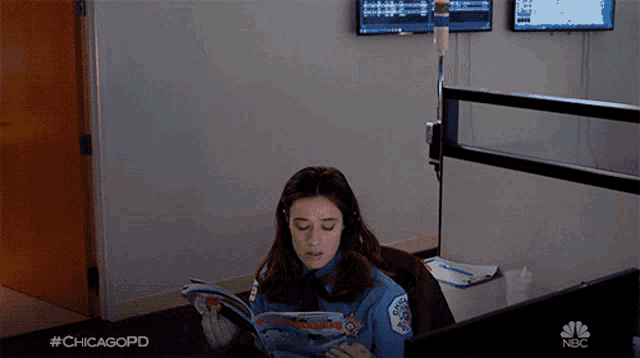 a woman in a chicago police uniform reads a book