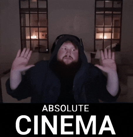 a man in a hooded jacket is standing in front of a sign that says absolute cinema ..