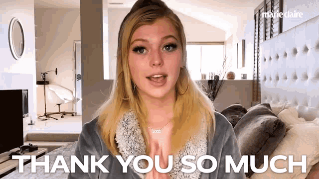 a woman says thank you so much in front of a marieclaire logo