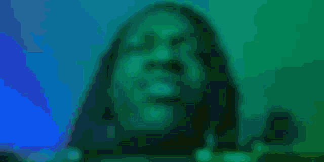 a green and yellow pixelated image of a person