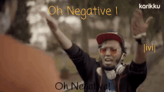 a man wearing headphones and a red hat says oh negative