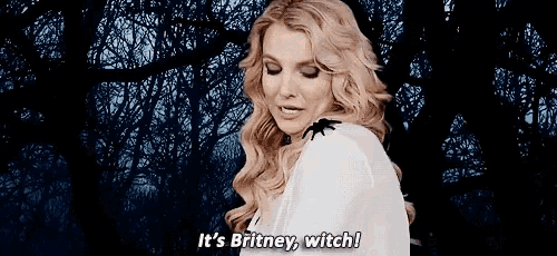 a woman in a white shirt with a spider on her shoulder says it 's britney witch .