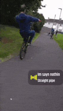 a man is riding a bike down a path with a sticker that says im sayn nothin straight pipe