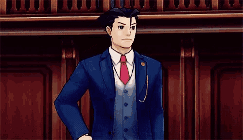 a man in a suit and tie is pointing his finger at the camera .