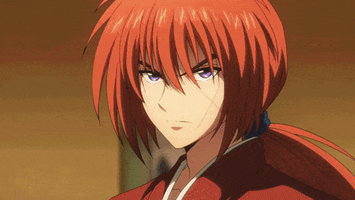 a close up of a person with red hair and blue eyes