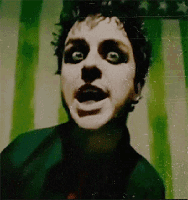 a close up of a person 's face with green eyes