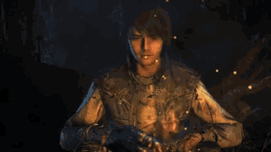 a man is holding a fire in his hands in a dark room in a video game .