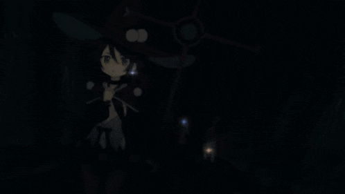 a girl in a witch costume is standing in a dark room