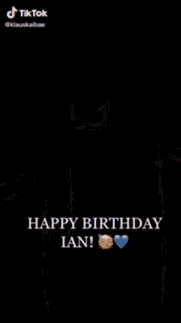 a man in a suit and tie is sitting down and says happy birthday ian