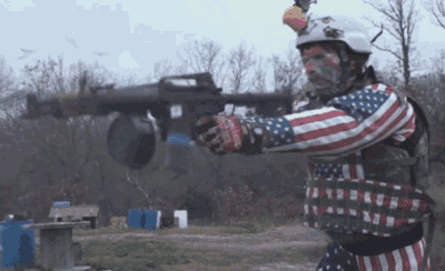 a man in an american flag outfit is holding a rocket launcher
