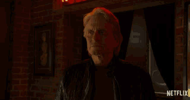 a man is standing in a dark room with a netflix logo in the corner
