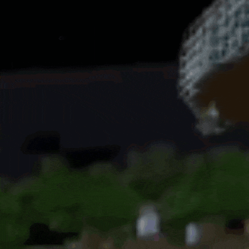 a blurred image of a person standing in front of a building at night