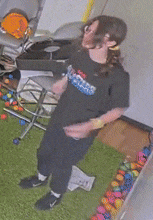 a girl wearing a black shirt that says ' avengers ' on it