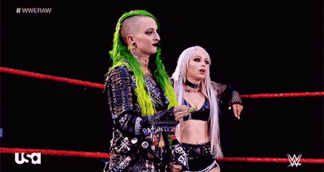 two women are standing in a wrestling ring with usa written on the bottom right