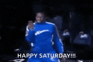 a man in a blue suit is dancing with the words `` happy saturday '' written below him .