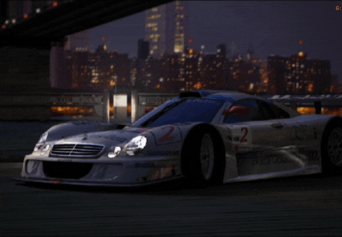 a silver sports car with the number 2 on the side