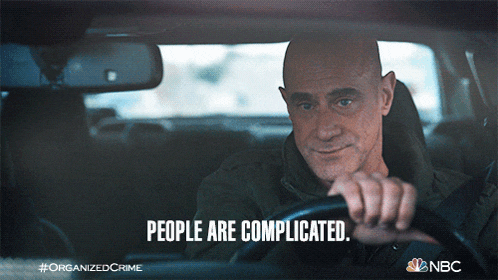 a man driving a car with the words people are complicated