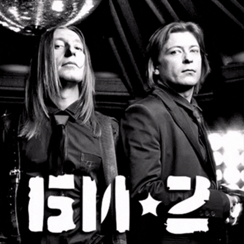 two men are standing next to each other with the word 2112 written on the bottom