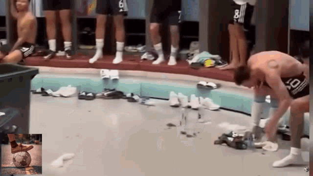a group of soccer players in a locker room with one wearing a shirt that says 8 on it