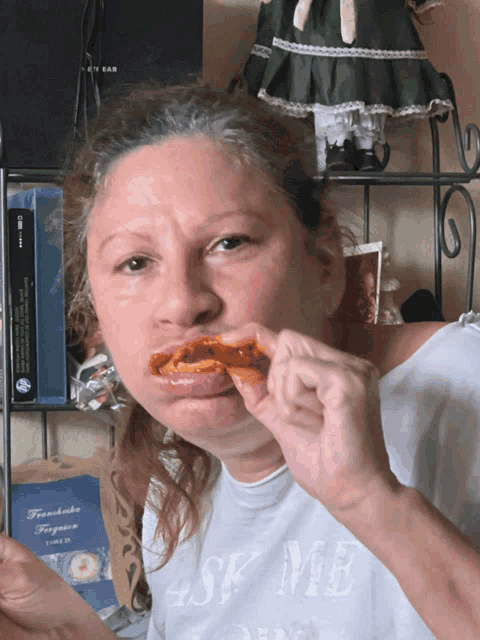 a woman wearing a t-shirt that says ask me