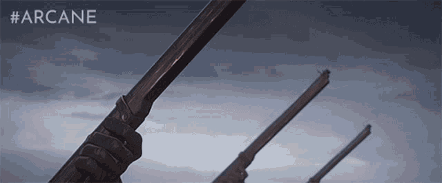 a row of guns against a cloudy sky with the word arcane on the bottom