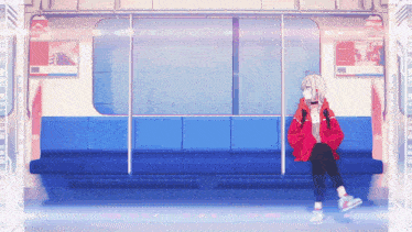 a girl in a red jacket is sitting on a blue couch on a train .