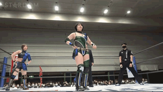 a female wrestler stands in a ring with the word stardom on the bottom
