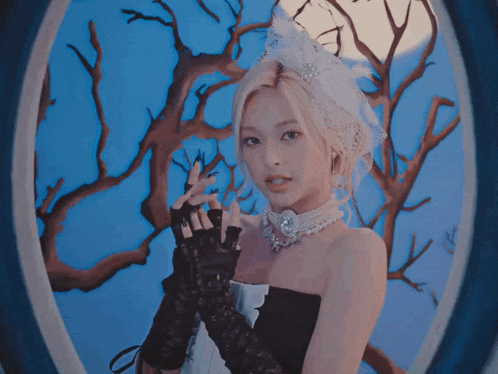a woman in a black dress and gloves looks out a window