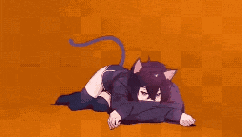 a girl in a cat costume is laying on the floor with her head on her knees .