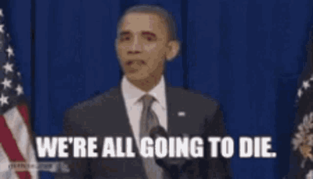 a man in a suit and tie is giving a speech and says we 're all going to die .