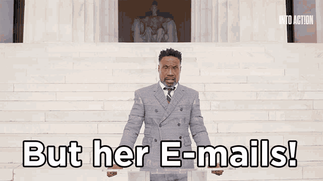 a man in a suit and tie stands in front of a podium with the words but her e-mails