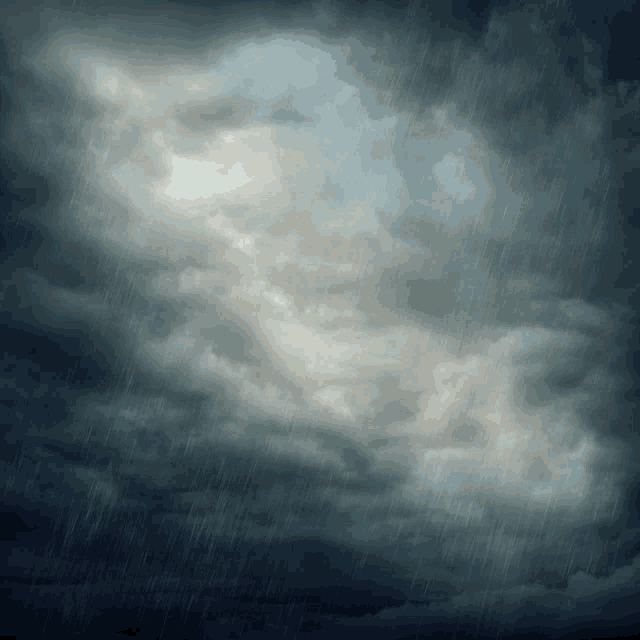 a dark cloudy sky with a few drops of rain