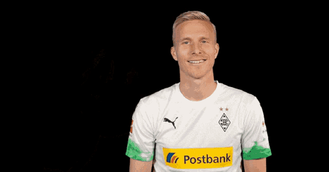 a man wearing a white shirt with a postbank logo