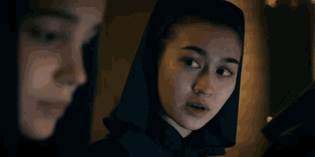 a girl with a hood on her head says " no one expects you to be "