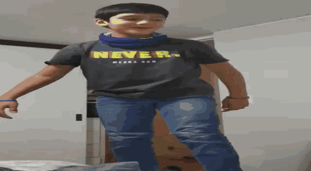 a boy is wearing a shirt that says never