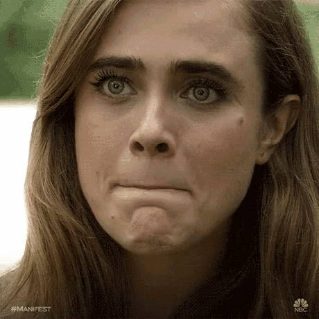 a close up of a woman 's face with #manifest written on the bottom left