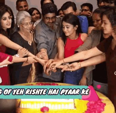 a group of people are gathered around a cake that says ' yeh rishte hai pyaar ke '