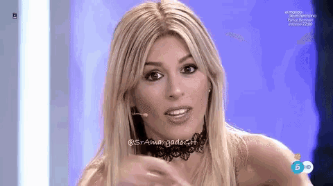 a woman wearing a choker and earrings is on a tv show
