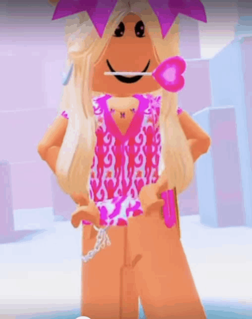 a girl in a pink dress is holding a pink heart lollipop .