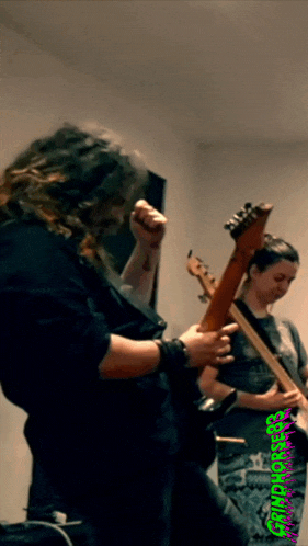 a man playing a guitar and a woman playing a guitar with the words grindcore written on the bottom