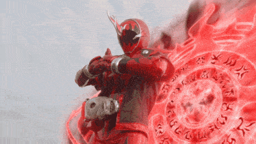 a man in a red superhero costume stands in front of a red circle with writing on it