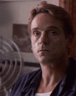 a man in a blue shirt is looking at something