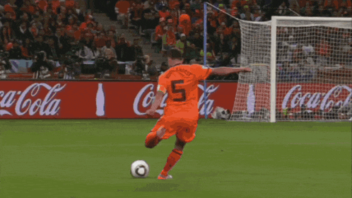 a soccer goalie jumps to catch a ball in front of a banner that says " uruguay home "