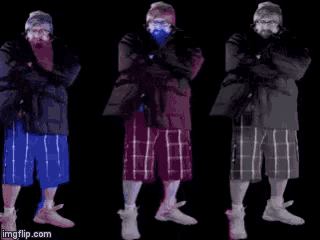 a man with a beard is wearing a jacket and plaid shorts in different colors